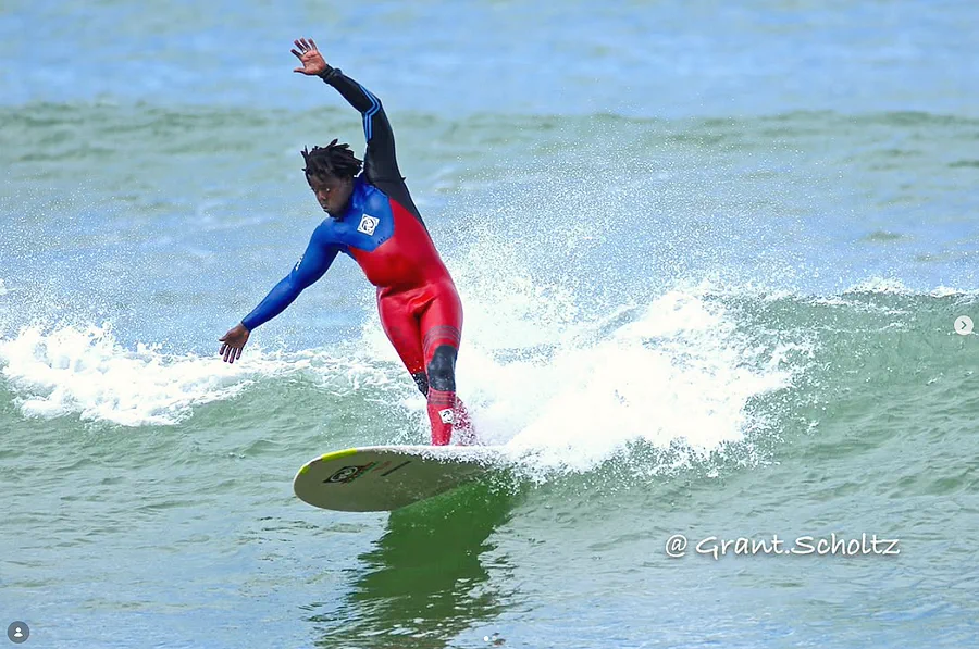 Kwezi riding a wave