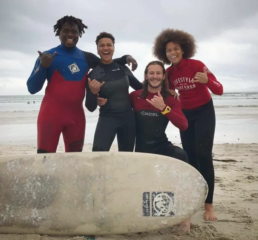 Kwezi with a group of students on the beach